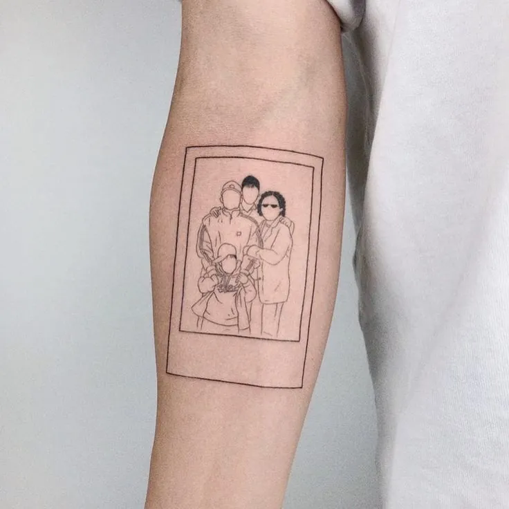Fine line tattoo of a framed family portrait on a forearm